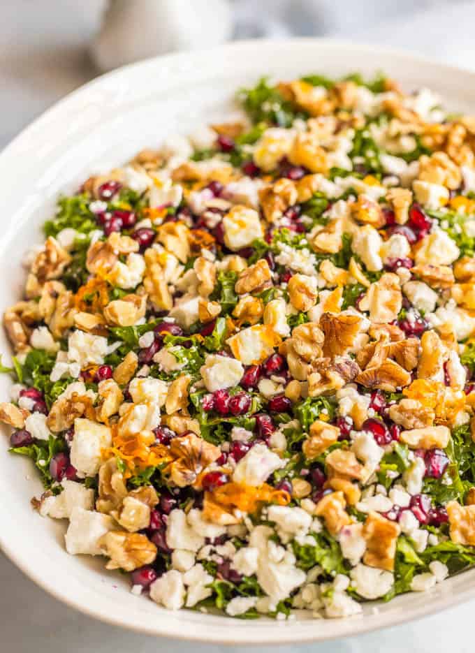 Winter kale salad with pomegranates, feta cheese, walnuts and an easy citrus dressing is perfect for a bright, fresh side dish or light lunch and can be prepped ahead for a healthy week! #kalesalad #healthysalad #easyrecipe #wintersalad | www.familyfoodonthetable