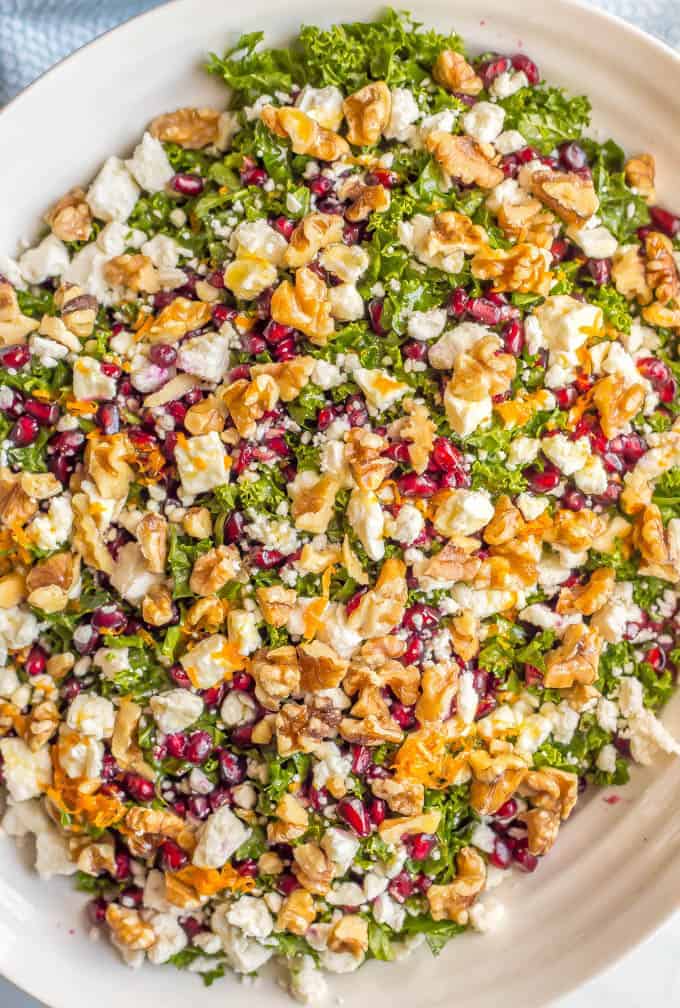 Winter kale salad with pomegranates, feta cheese, walnuts and an easy citrus dressing is perfect for a bright, fresh side dish or light lunch and can be prepped ahead for a healthy week! #kalesalad #healthysalad #easyrecipe #wintersalad | www.familyfoodonthetable