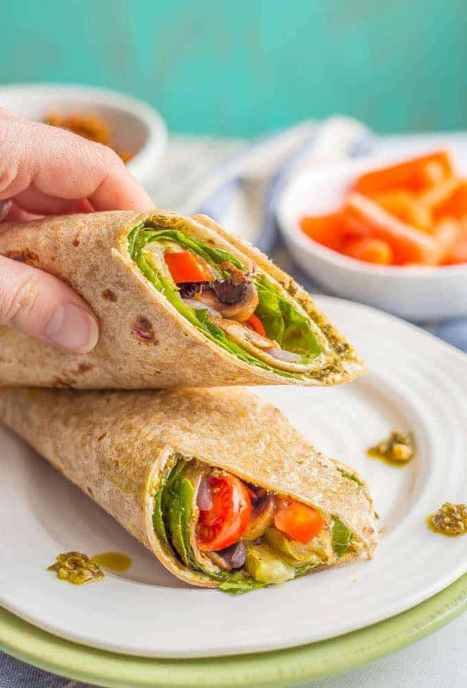 This roasted veggie wrap with pesto and goat cheese is the ultimate in lunchtime satisfaction! This vegetarian wrap can be prepped ahead and reheated and can also be customized to include your favorite vegetables! #veggiewrap #veggielunch #healthylunch | www.familyfoodonthetable.com