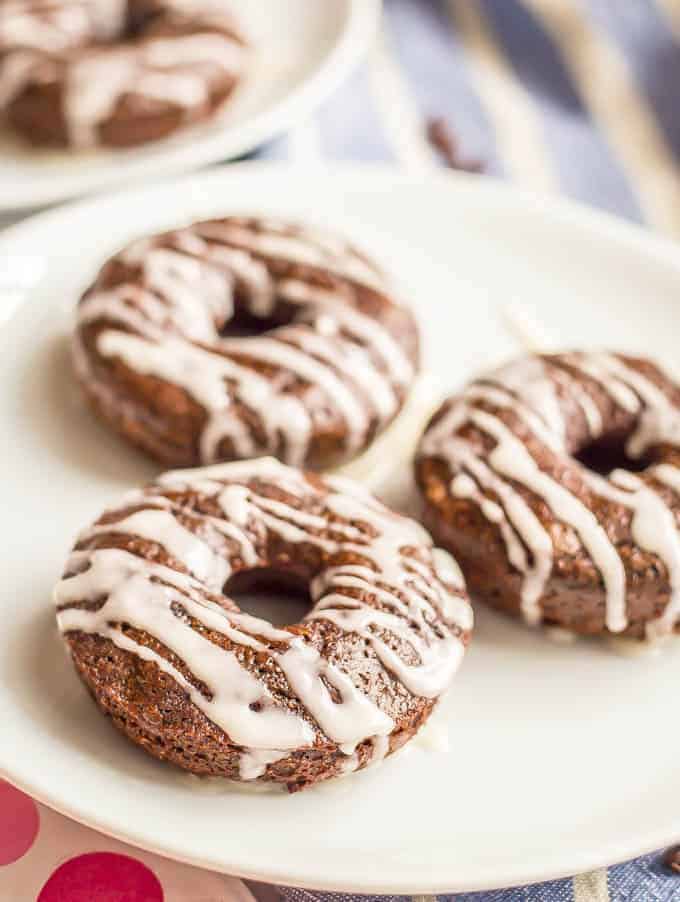 Whole wheat chocolate baked donuts have double the chocolate and none of the guilt! They come together quickly and make for a super fun healthy breakfast! Serve with an easy vanilla glaze, Nutella or a peanut butter frosting. #chocolatebreakfast #bakeddonuts #healthydonuts 