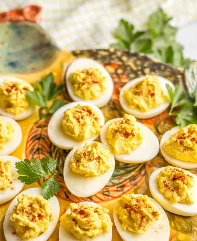 Close-up side angle shot of Mom's classic Southern deviled eggs on a traditional deviled eggs serving platter in the shape of a hen