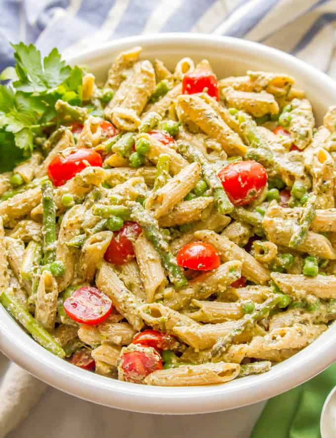 This warm and creamy pesto pasta with spring vegetables is an easy one-pot pasta recipe with peas, asparagus, and ricotta and Parmesan cheeses. It’s great as a light vegetarian meal or as a side dish at dinner! #pestopasta #vegetarianpasta #springpasta | www.familyfoodonthetable.com