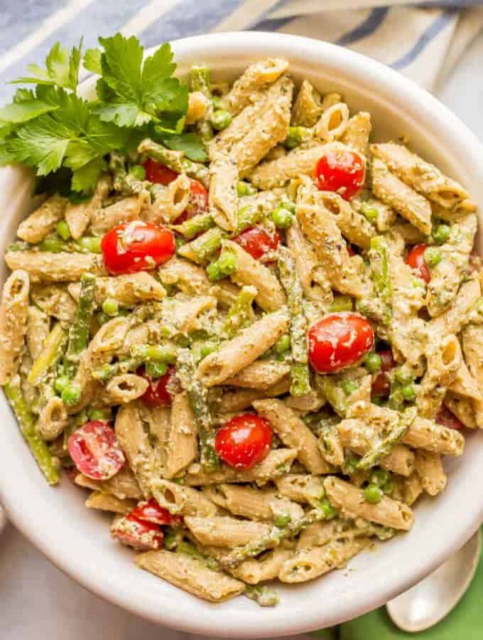 This warm and creamy pesto pasta with spring vegetables is an easy one-pot pasta recipe with peas, asparagus, and ricotta and Parmesan cheeses. It’s great as a light vegetarian meal or as a side dish at dinner! #pestopasta #vegetarianpasta #springpasta | www.familyfoodonthetable.com