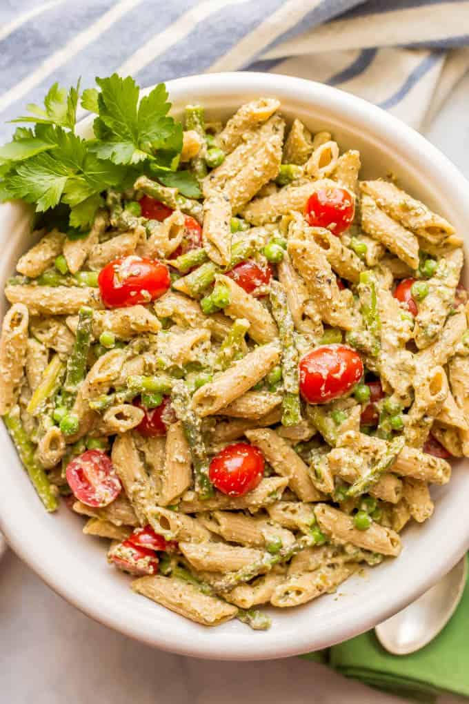 This warm and creamy pesto pasta with spring vegetables is an easy one-pot pasta recipe with peas, asparagus, and ricotta and Parmesan cheeses. It’s great as a light vegetarian meal or as a side dish at dinner! #pestopasta #vegetarianpasta #springpasta | www.familyfoodonthetable.com