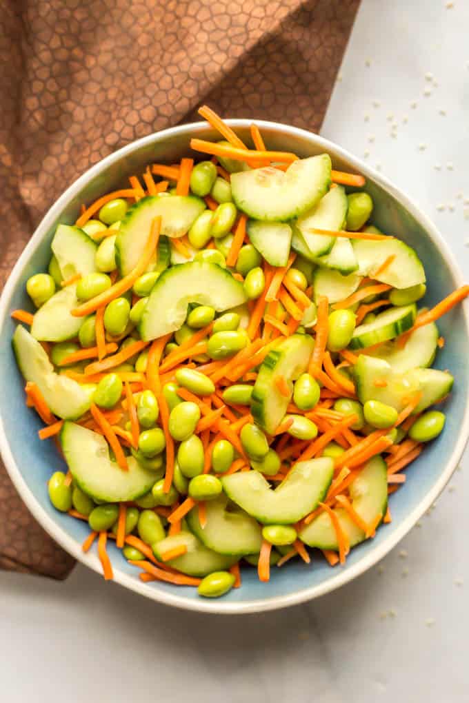 Edamame carrot and cucumber salad in a blue bowl without any dressing