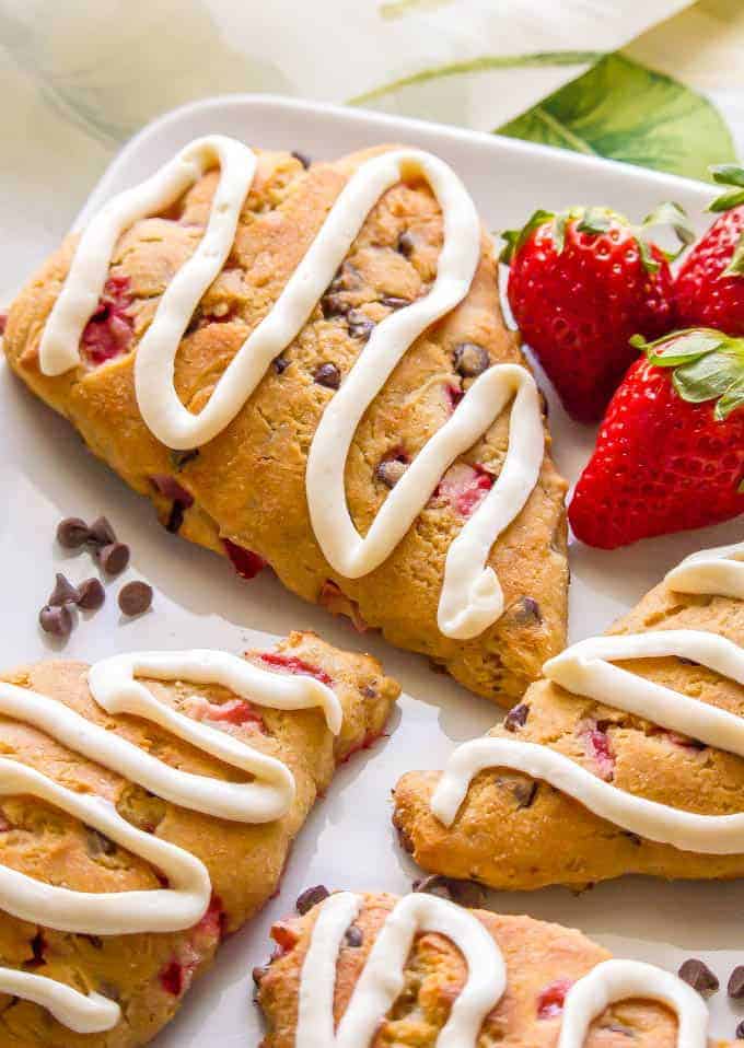 These healthy strawberry scones are whole wheat, naturally sweetened, low in fat and perfect for breakfast or brunch! You can add in some optional mini chocolate chips and/or serve with any of my glaze topping ideas for an extra special treat! #strawberryrecipes #scones #brunchrecipes | www.familyfoodonthetable.com