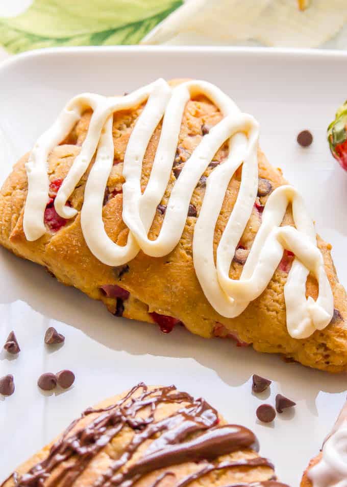 Close-up of a whole wheat strawberry scone with a cream cheese frosting on top