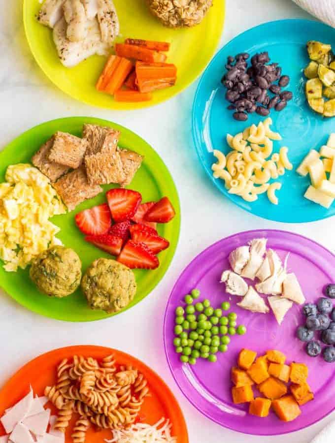 Colorful kid plates with an array of finger food options