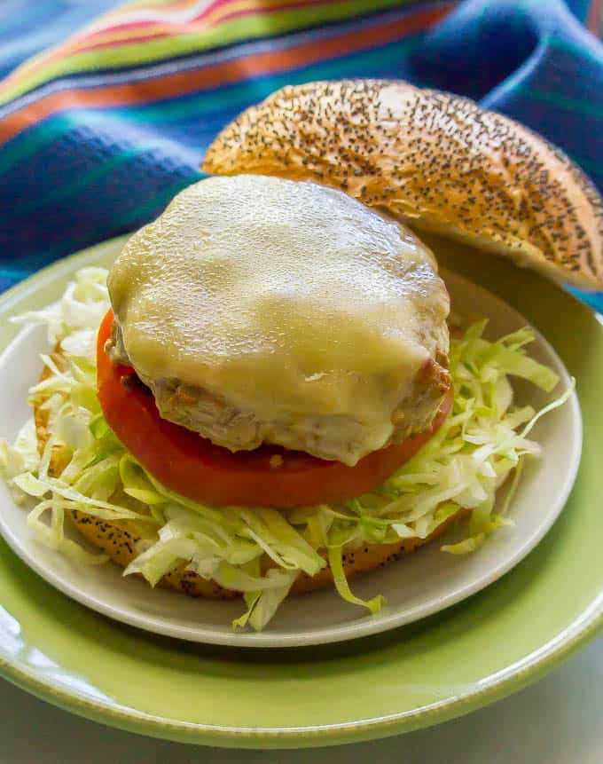 Fiesta turkey burger with melted cheese on a bun with shredded lettuce and tomato