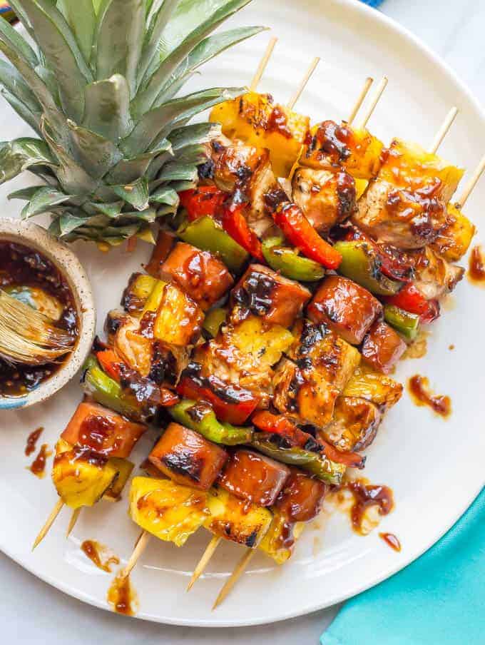 Teriyaki chicken pineapple kabobs are a fun and flavorful recipe for the grill (or oven) with tender chicken, peppers, fresh sweet pineapple and an easy teriyaki sauce that doubles as a marinade and sauce for basting and serving. Perfect for a family dinner or a BBQ party! | www.familyfoodonthetable.com