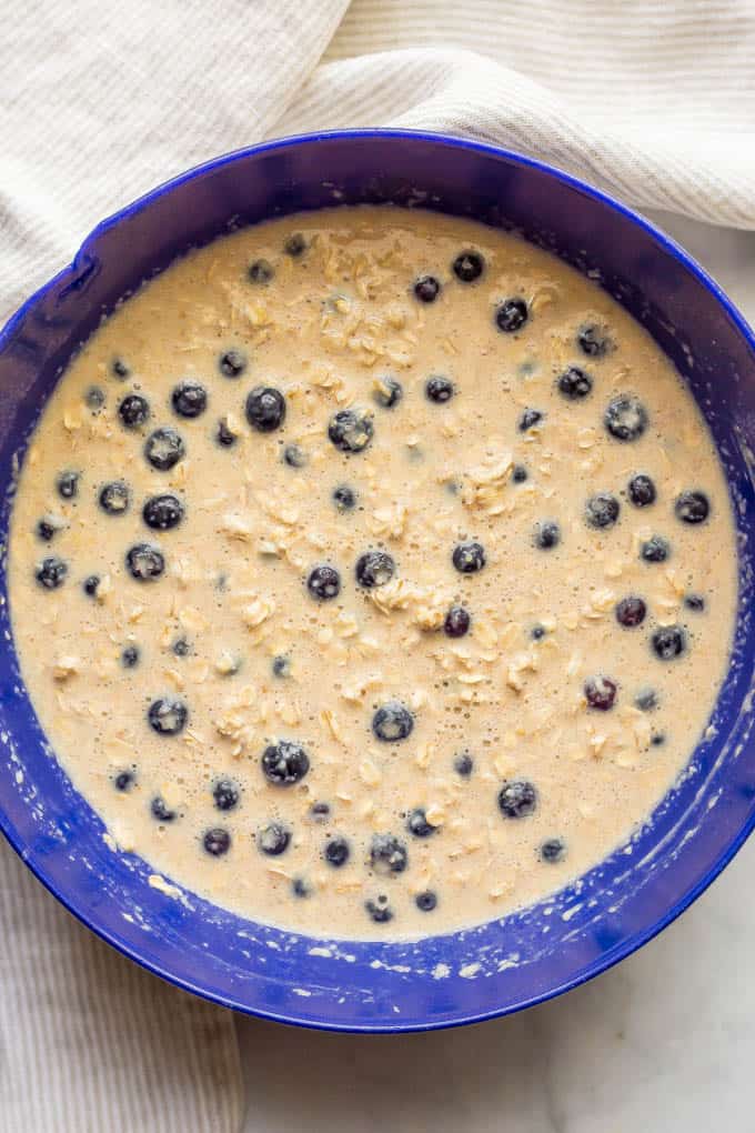 Batter for healthy blueberry baked oatmeal in a large blue bowl
