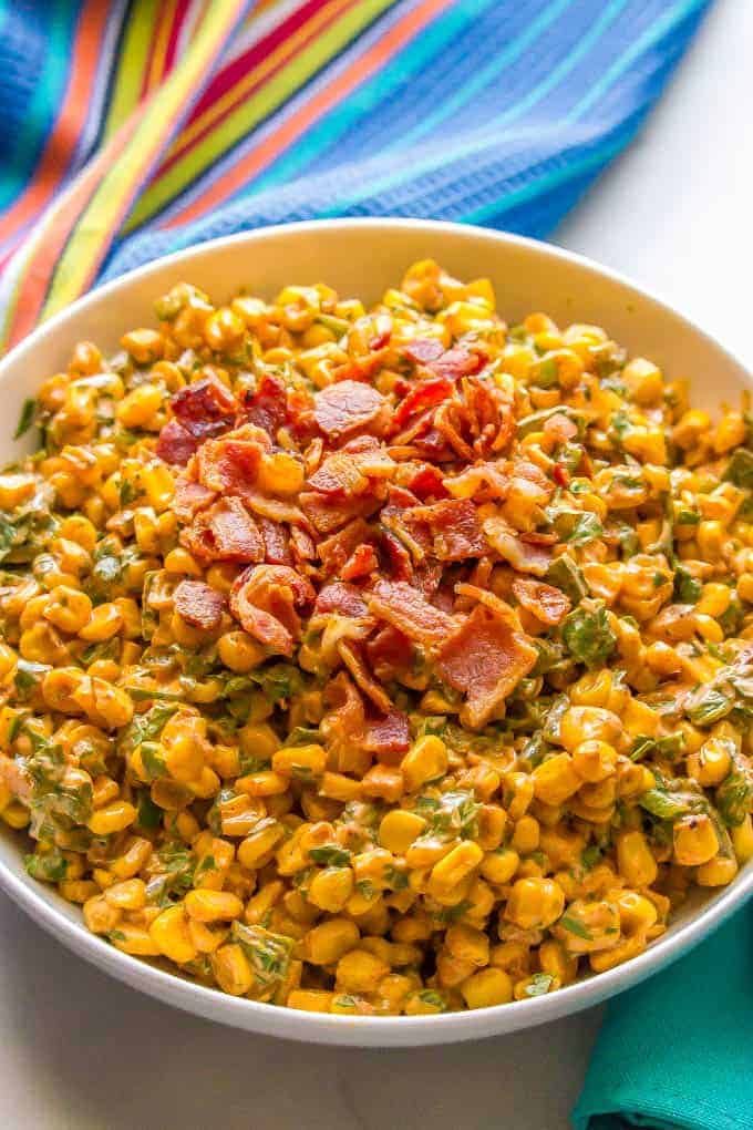 Summer corn salad with roasted poblanos, cilantro and a creamy dressing is a fresh and flavorful veggie side dish. It’s great served in individual cups for a portable and fun BBQ recipe everyone will love! #corn #cornsalad #bbqrecipes | www.familyfoodonthetable.com