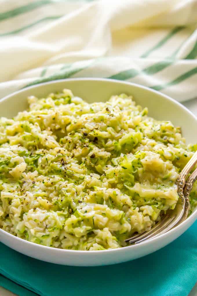 Easy cheesy zucchini brown rice is a one-pot side dish with whole grains, a big dose of veggies and plenty of cheesy goodness! It’s a great way to get your family to eat their vegetables and it’s ready in about 30 minutes. #brownrice #zucchini #veggierice #sidedish #healthykids #easyrecipe