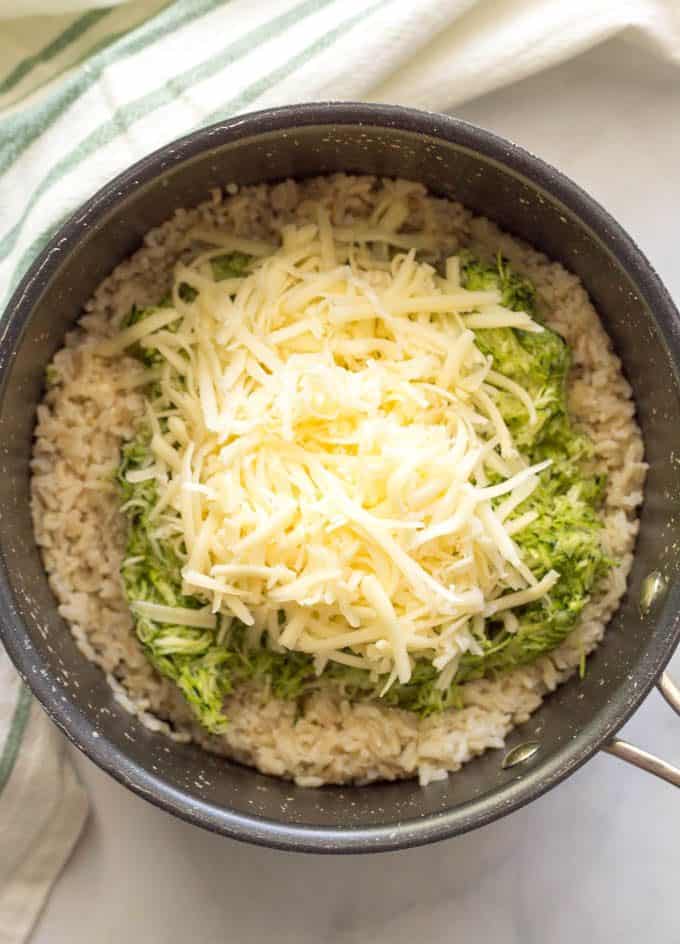 Easy one-pot cheesy zucchini brown rice being cooked in a pot