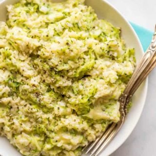 Easy cheesy zucchini brown rice is a one-pot side dish with whole grains, a big dose of veggies and plenty of cheesy goodness! It’s a great way to get your family to eat their vegetables and it’s ready in about 30 minutes. #brownrice #zucchini #veggierice #sidedish #healthykids #easyrecipe