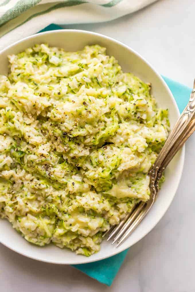 Easy cheesy zucchini brown rice is a one-pot side dish with whole grains, a big dose of veggies and plenty of cheesy goodness! It’s a great way to get your family to eat their vegetables and it’s ready in about 30 minutes. #brownrice #zucchini #veggierice #sidedish #healthykids #easyrecipe