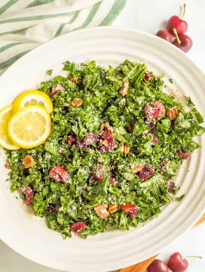 Massaged kale salad with cherries, pecans and Parmesan is perfect for summertime when fresh cherries are in season! It’s easy to make and great for dinner, BBQs, picnics and parties! #kalesalad #cherryrecipes #summersalad | www.familyfoodonthetable.com