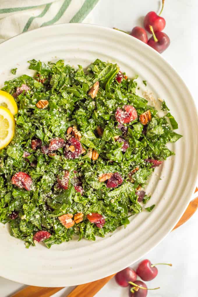 Massaged kale salad with cherries, pecans and Parmesan is perfect for summertime when fresh cherries are in season! It’s easy to make and great for dinner, BBQs, picnics and parties! #kalesalad #cherryrecipes #summersalad | www.familyfoodonthetable.com