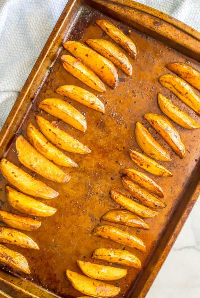 Easy spicy oven roasted potato wedges on a sheet pan after being baked