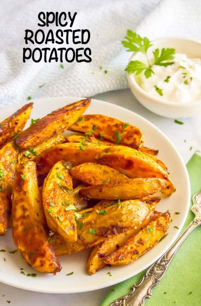 Easy spicy roasted potatoes require just a few pantry ingredients to create a truly delicious side dish with a bit of a kick! These potato wedges are crispy and crunchy on the outside with a tender, fluffy center. #roastedpotatoes #potatoes #spicyfood