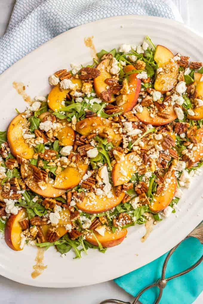 Arugula salad with peaches, pecans and goat cheese with balsamic vinaigrette is perfect for an easy, light and delicious summer side salad! #arugulasalad #peachrecipes #summersalad #saladrecipes #lowcarbrecipes #glutenfreerecipes