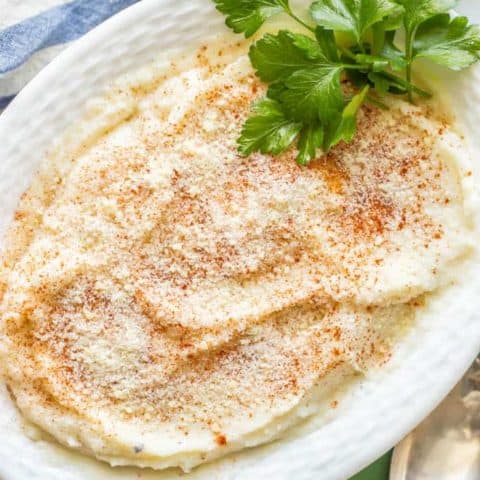 Healthy mashed cauliflower is a creamy, smooth and an easy, delicious low-carb option for a dinner side dish. Just 4 ingredients and ready in just 20 minutes, you’ll love this mashed cauliflower on its own or with your favorite potato toppings! #cauliflower #lowcarb #glutenfree #sidedish