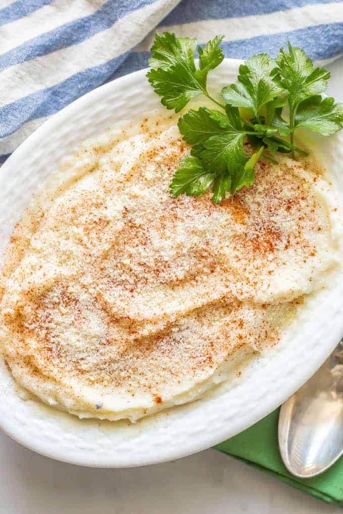 Healthy mashed cauliflower is a creamy, smooth and an easy, delicious low-carb option for a dinner side dish. Just 4 ingredients and ready in just 20 minutes, you’ll love this mashed cauliflower on its own or with your favorite potato toppings! #cauliflower #lowcarb #glutenfree #sidedish