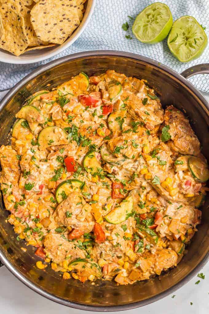 Queso chicken skillet with vegetables is an easy, cheesy, delicious one-pot dinner the whole family will enjoy! Great with rice, tortillas or chips! #quesochicken #chickendinner #easychickenrecipes #familydinner #chickenrecipes