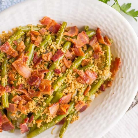 Southern style green beans with bacon and breadcrumbs served in a white bowl