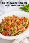 An oval serving bowl with tender green beans topped with cooked, crumbled bacon and buttery breadcrumbs and a text overlay on the image.