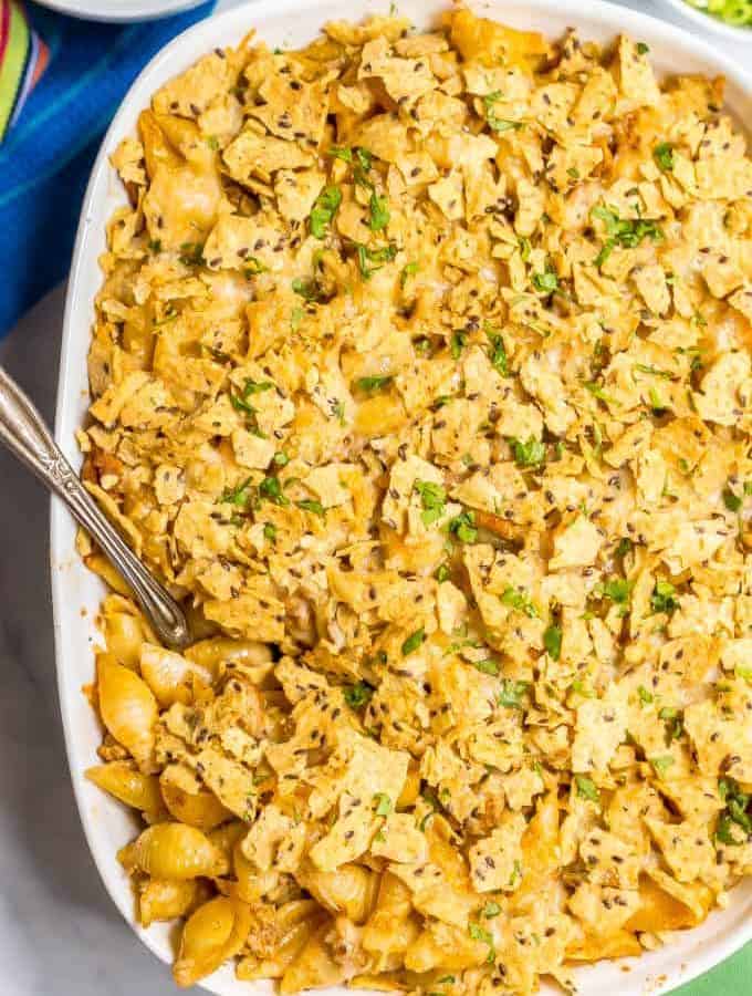 Baked taco mac and cheese casserole is an easy, family-friendly dinner with a creamy sauce and big taco flavor. Add your favorite toppings and dig in! #macandcheese #macaroni #pastadinner #tacos #tacodinner