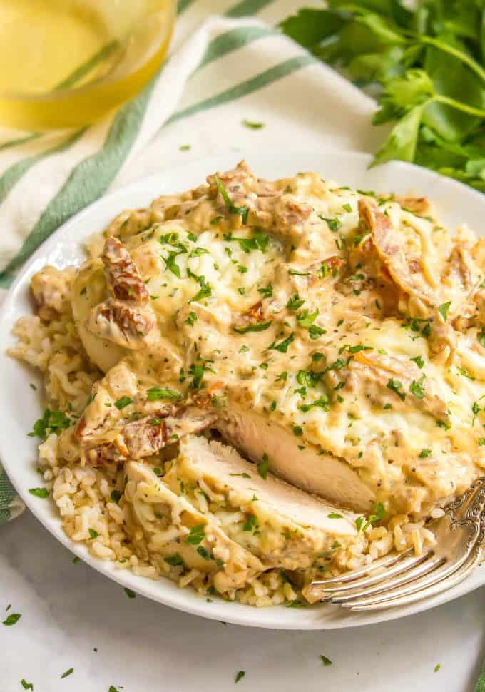 Easy creamy Italian chicken skillet served over brown rice on a white plate