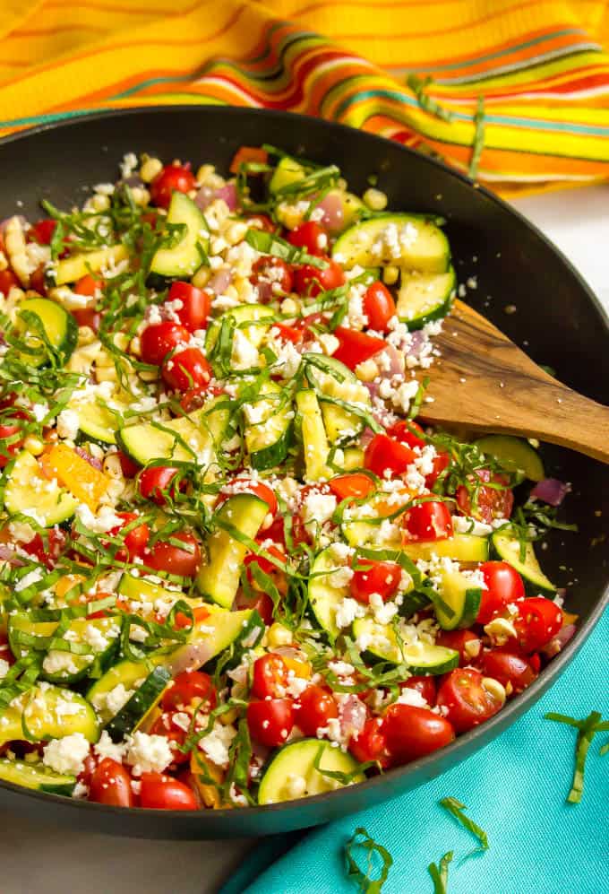 Summer veggie skillet is a colorful, delicious and healthful one-pan side dish with zucchini, peppers, tomatoes, and corn, finished with fresh herbs and cheese! #summer #veggies #vegetarian