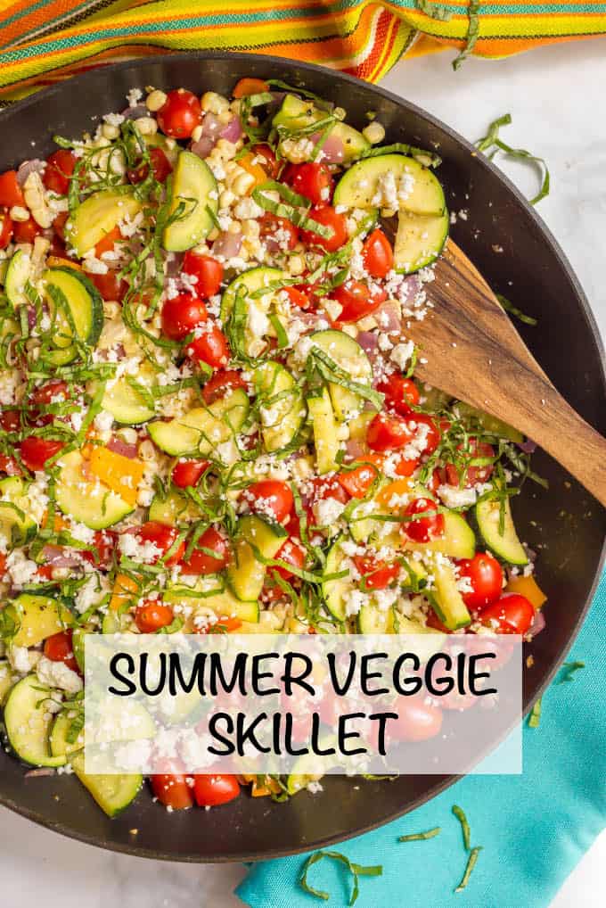 Summer veggie skillet is a colorful, delicious and healthful one-pan side dish with zucchini, peppers, tomatoes, and corn, finished with fresh herbs and cheese! #summer #veggies #vegetarian