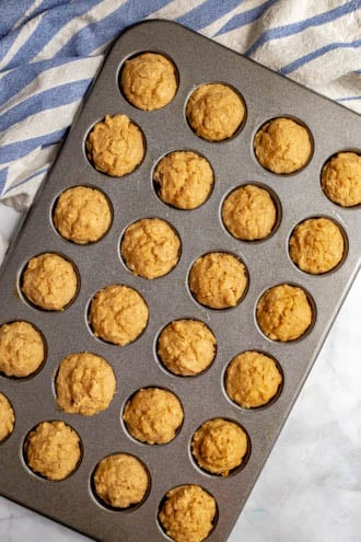 Baked apple cinnamon donut holes in a mini muffin tin