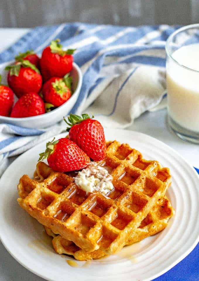 Easy whole wheat waffles are perfectly fluffy on the inside and crispy on the outside. These waffles are naturally sweetened and the extras freeze great! #waffles #breakfast #brunch