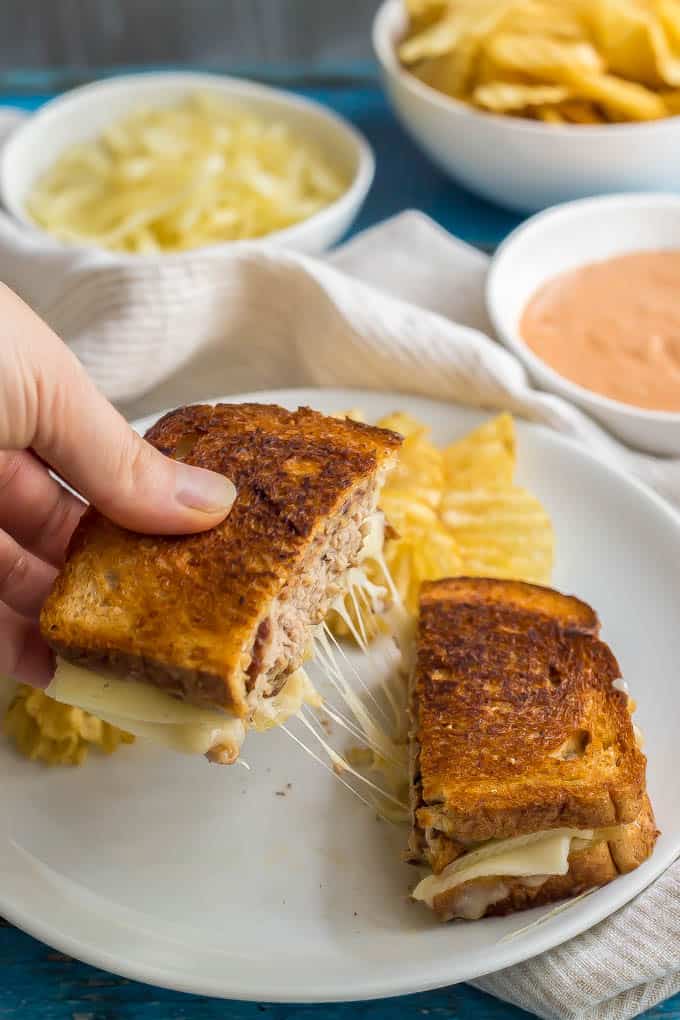 Ground turkey patty melt sandwich being pulled apart with melty cheese in the middle