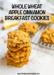 A stack of healthy apple cinnamon breakfast cookies set near a cooling rack of cookies.