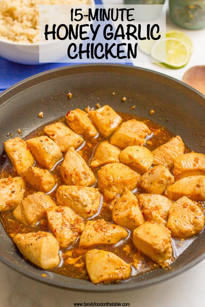 Honey garlic chicken in a dark skillet with plenty of sauce and a text overlay on the photo