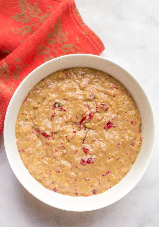 Whole wheat cranberry sauce muffin batter in a white bowl