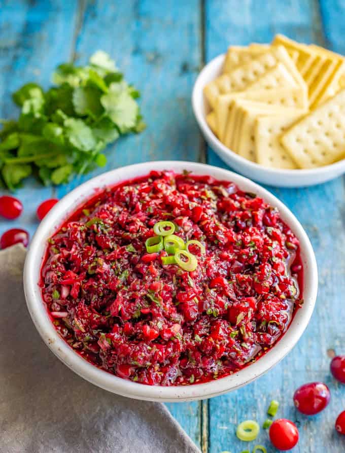 Fresh cranberry salsa with cilantro, jalapeño and citrus has big, bright flavors and comes together in just 5 minutes! Goes great with crackers or bread with cream cheese for an appetizer, served with chips, over baked brie or on sandwiches! #Thanksgivingrecipes #holidayrecipes #holidayapptizer #cranberries #salsa