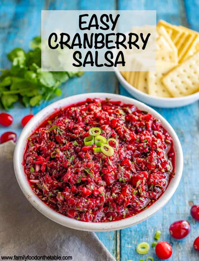 Fresh cranberry salsa with cilantro, jalapeño and citrus has big, bright flavors and comes together in just 5 minutes! Goes great with crackers or bread with cream cheese for an appetizer, served with chips, over baked brie or on sandwiches! #Thanksgivingrecipes #holidayrecipes #holidayapptizer #cranberries #salsa