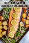 A sheet pan with a long piece of roasted salmon topped with lemon slices alongside roasted potatoes and green beans.