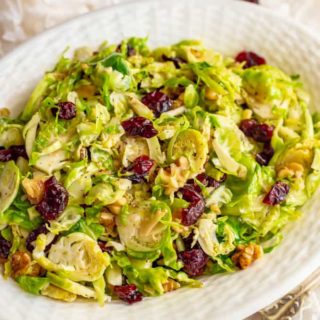 Shredded Brussels sprouts with cranberries and walnuts are a super quick and easy side dish with great flavors! It’s perfect for the holidays or just a busy weeknight! #Brusselssprouts #sidedish #veggies #holidays #Thanksgiving #Christmas