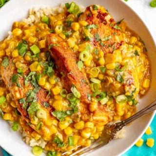 Skillet chicken with creamed corn is an easy weeknight dinner that’s ready in just 25 minutes. Serve over rice or quinoa to soak up the delicious, creamy corn sauce! #corn #chickenrecipe #chickendinner #easyrecipe