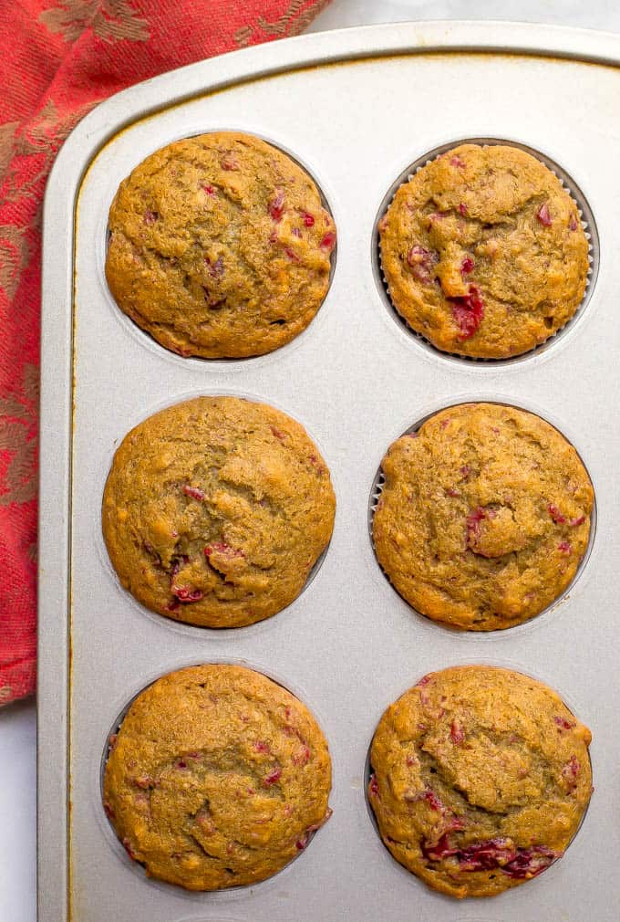 Whole wheat cranberry sauce muffins in a muffin tin after baking