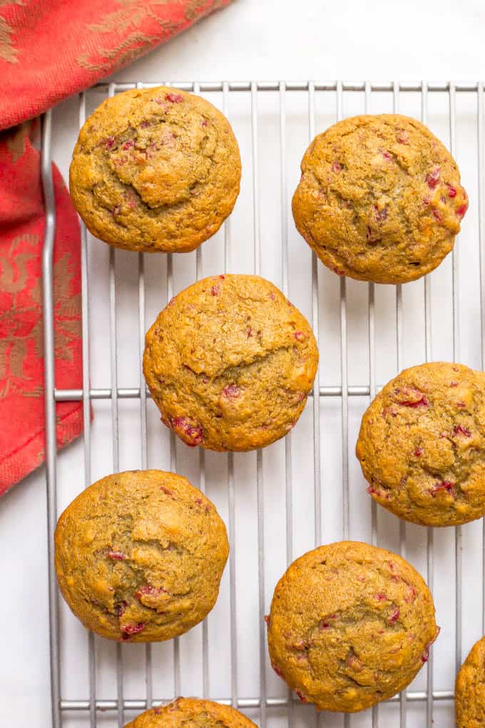 Whole wheat cranberry sauce muffins are a beautiful and fun way to use extra cranberry sauce! Top with a smear of butter and enjoy for a delicious, festive holiday breakfast! #cranberries #cranberrysauce #thanksgiving #holidays #muffins