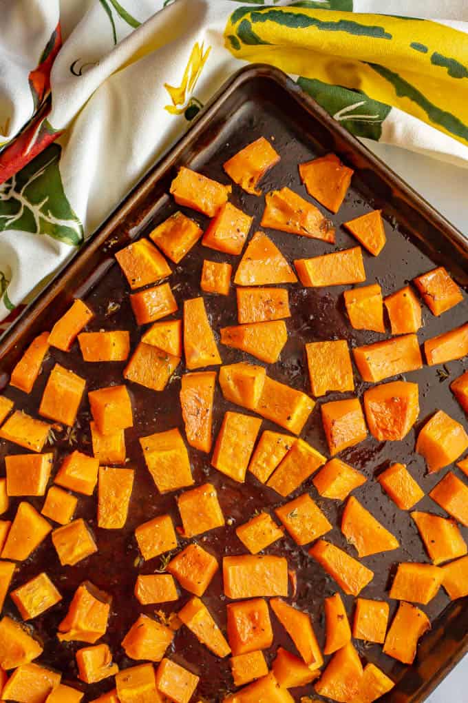 Roasted butternut squash pieces on a baking tray