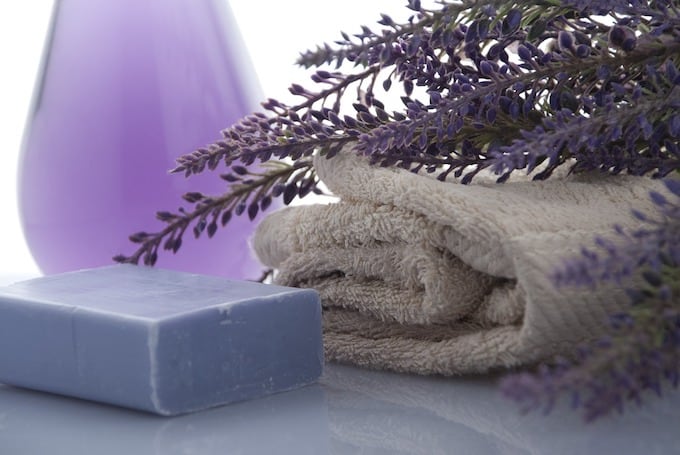Cozy gifts for moms in the bathroom, including a bar of soap, towel and purple accents