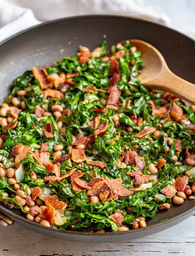 Collard greens and beans with bacon are a favorite Southern recipe, made quick and easy here with a few shortcuts. It’s great for a New Year’s Day meal or an anytime dinner side dish! #collards #beans #fieldpeas #sidedish #newyearsfood